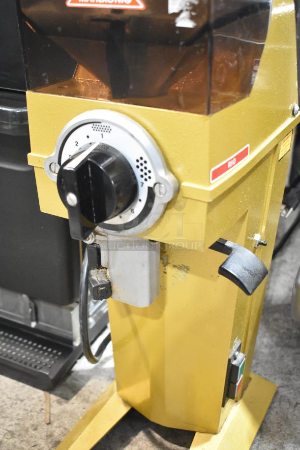 Mahlkonig RIO commercial bean grinder, yellow, 115V 1 phase. Features dial settings and RIO label, countertop model.