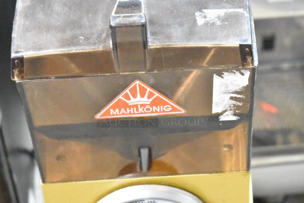 Mahlkonig RIO Commercial Bean Grinder, 115V, 1 Phase. Features visible Mahlkonig logo and scratches on the casing.