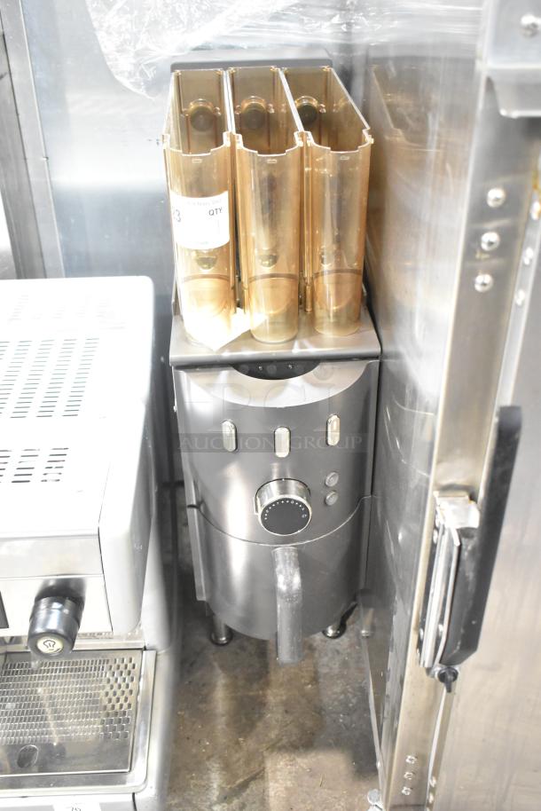 Commercial countertop coffee tower machine with multiple clear compartments and control knobs. Slightly used condition.