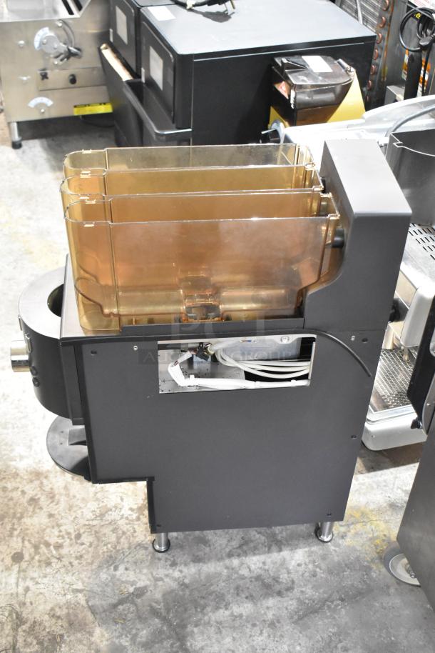 Commercial countertop coffee tower machine in black, featuring multiple compartments and visible wiring. Used condition.