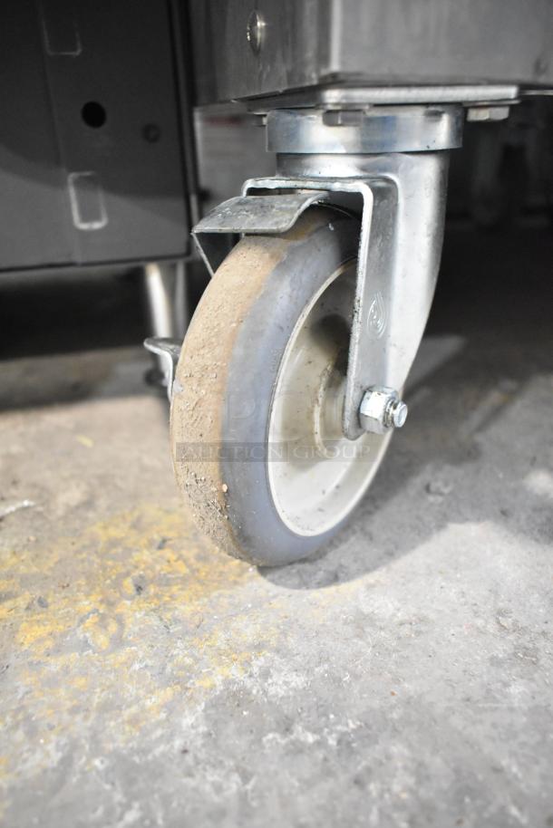 CresCor 1000HHSS2DX heated cabinet caster detail, showing rugged commercial caster on concrete floor.