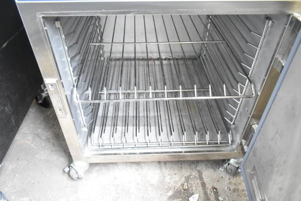 2024 Alto Shaam 750-S heated holding cabinet, stainless steel, commercial casters, open door view, clean interior.