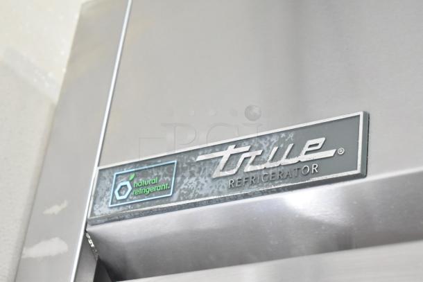 2019 True TG2R-2S-HC commercial cooler, stainless steel, 2 doors, on casters, natural refrigerant label visible.