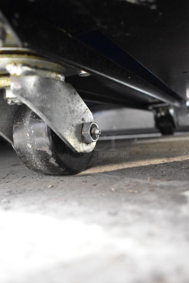 Close-up of commercial caster wheel on a 2019 True TG2R-2S-HC 2 Door Reach In Cooler, 115 volts, 1 phase.