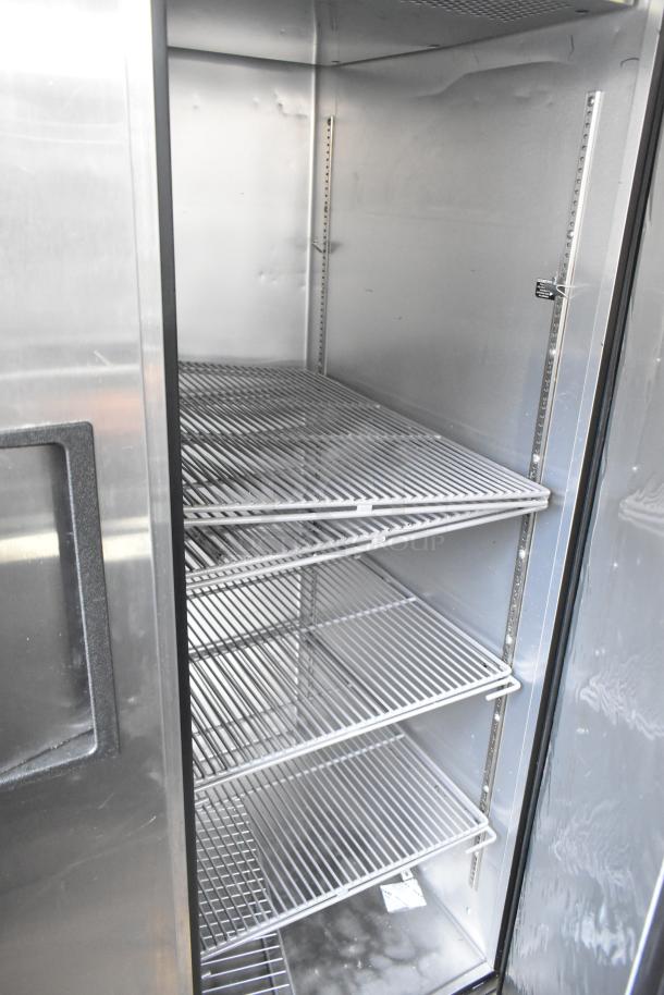 2019 True TG2R-2S-HC 2-door commercial reach-in cooler, on casters, features stainless steel interior, four shelves, excellent condition.