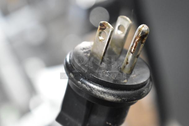 Alt text: Close-up of a power plug from a 2019 Ditting KR1203 Commercial Coffee Grinder, showing wear and rust.