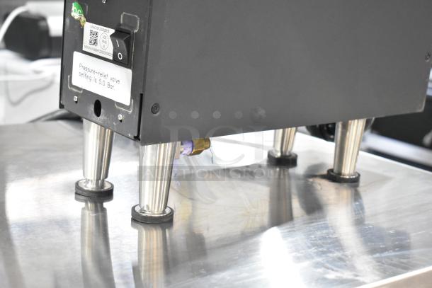 Clover Vertica CM9700 water boiler/dispenser. 208V, 1 phase. Pressure-relief valve set to 5.0 Bar.