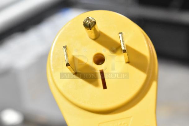 Close-up of a yellow power plug suitable for a Clover Vertica CM9700 water boiler, indicating 208 volts, 1 phase connection.