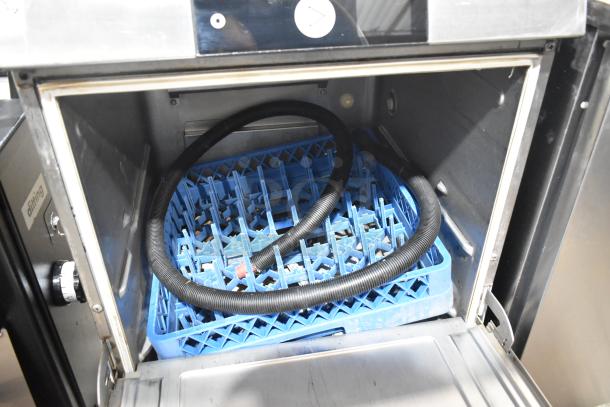 2024 Hobart LXNR stainless steel commercial undercounter dishwasher, showing interior with blue dish rack and hose.