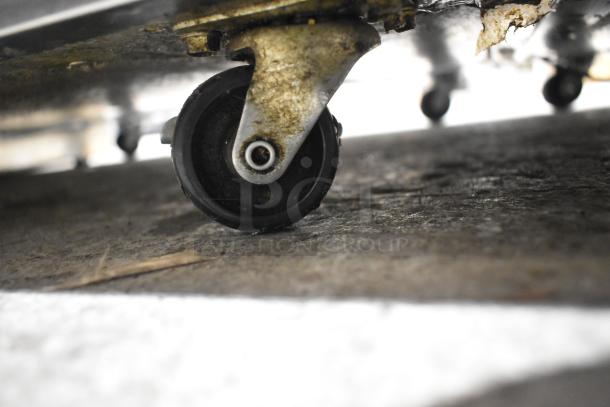 2022 Delfield 406P-STAR2 commercial undercounter cooler caster, showing wear, for easy mobility.