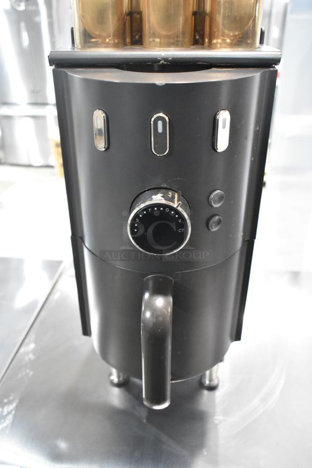 Commercial countertop coffee tower machine with black finish, control dial, and dual spouts; in good condition.