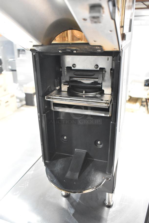 Commercial countertop coffee tower machine with open interior view. Features robust metal parts, suited for high-volume use.