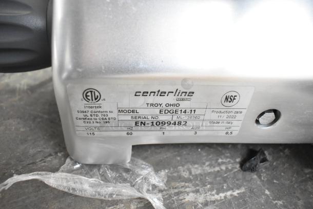 BRAND NEW Hobart EDGE14-11 14" Commercial Meat Slicer. Features blade sharpener, 115V, 1 phase. Model label includes specs.