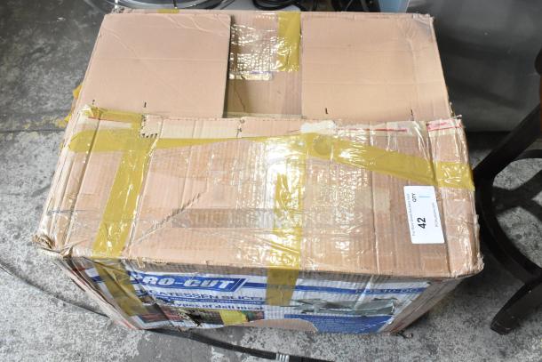 Cardboard box containing a Pro-cut KDS-10-DC meat slicer, showing wear and tape, with visible label indicating item number 42.