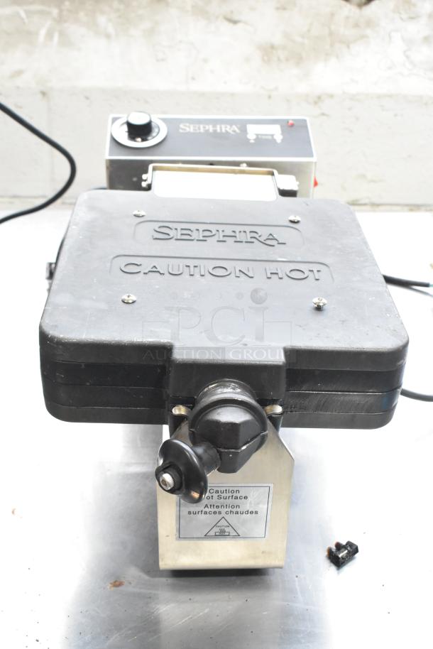 Sephra SERTWFL01 Countertop Waffle Baker, black, 110-120V, with caution markings, in used condition.