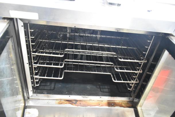 Vulcan VC5ED-SEFCAM5 commercial convection oven with view-through doors and racks shown, thermostat controls visible.