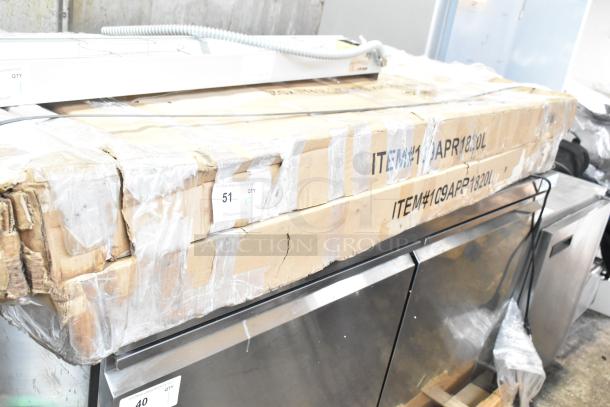 Two new Regency 109APR1820L end load bun pan racks in original packaging, marked with item and quantity labels.