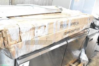 Two new Regency 109APR1820L end load bun pan racks in original packaging, marked with item and quantity labels.