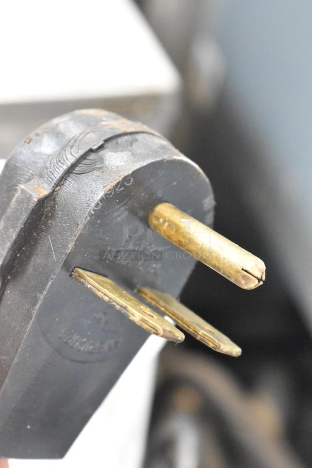 Close-up of Proluxe DP2350 dough press plug. Shows a 208-volt connection, NEMA 6-20P configuration. Slight wear visible.