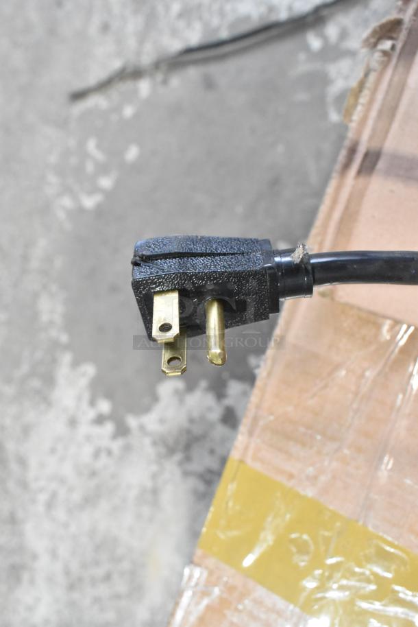 Close-up of power plug for 2019 True T-35 Commercial Cooler, 115 volts, 1 phase, showing three-prong connection.