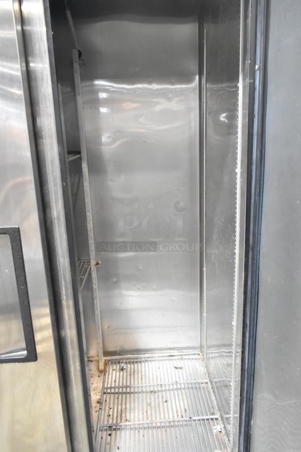 2019 True T-35 commercial reach-in cooler, 2 doors, 115 volts, 1 phase, clean interior, metal shelving, minor wear visible.