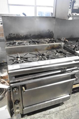 Jade Range commercial gas-powered 6 burner, 2-tier range with oven, backsplash, and commercial casters, used condition.