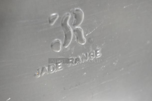Embossed Jade Range logo on a stainless steel surface, indicating brand authenticity.