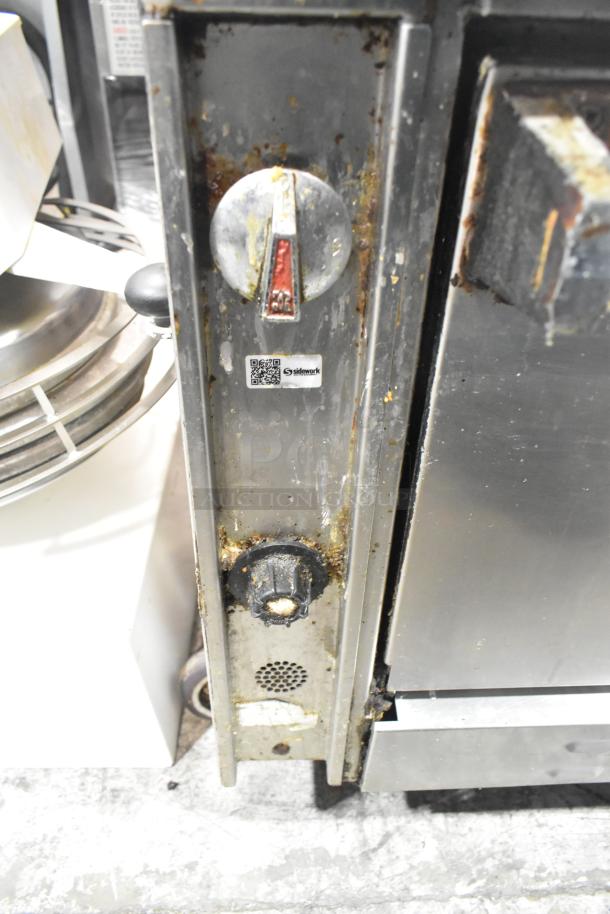 Jade Range 6 burner gas range with oven, 2 tiers, backsplash, visible wear, on commercial casters. QR code on panel.