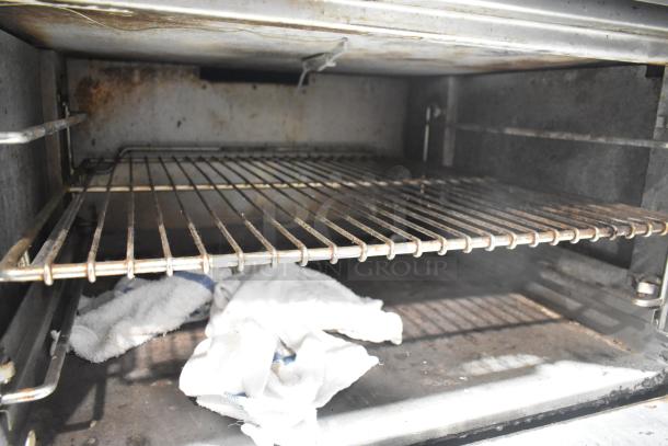 Jade Range commercial gas oven interior with wire rack; shows wear, suitable for heavy-duty kitchen use.