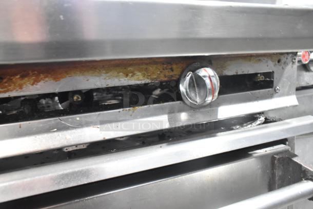 Jade Range commercial gas-powered 6 burner range with oven, back splash, and casters. Visible wear near control knob.