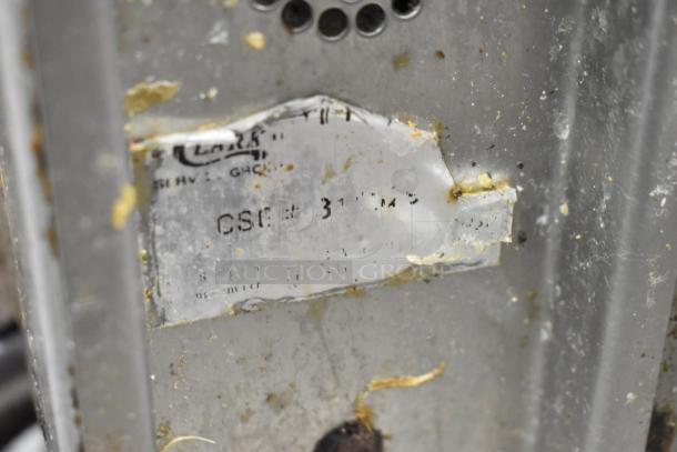 Jade Range commercial gas 6 burner 2 tier range, with oven and backsplash, on casters. Visible wear and markings on label.