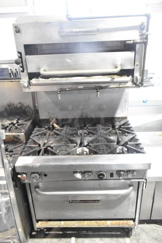 Southbend commercial gas range, six burners, oven, salamander cheese melter, backsplash, on casters, visible wear.