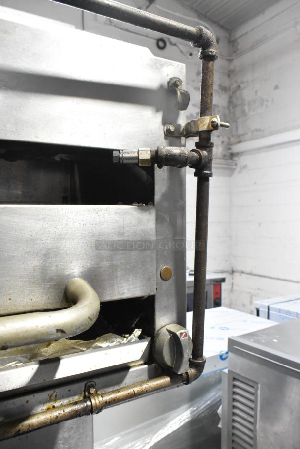 Southbend commercial gas-powered range, featuring 6 burners, oven, salamander cheese melter, and back splash on casters.