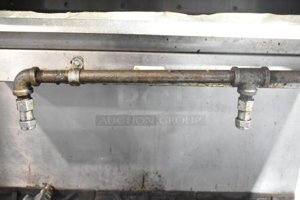 Southbend Commercial Gas Range: 6 burners, oven, salamander cheese melter, backsplash, on casters. Visible gas fittings.