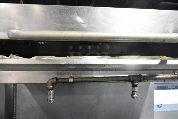 Southbend commercial gas range with 6 burners, oven, salamander cheese melter, and backsplash on casters. Slight wear visible.