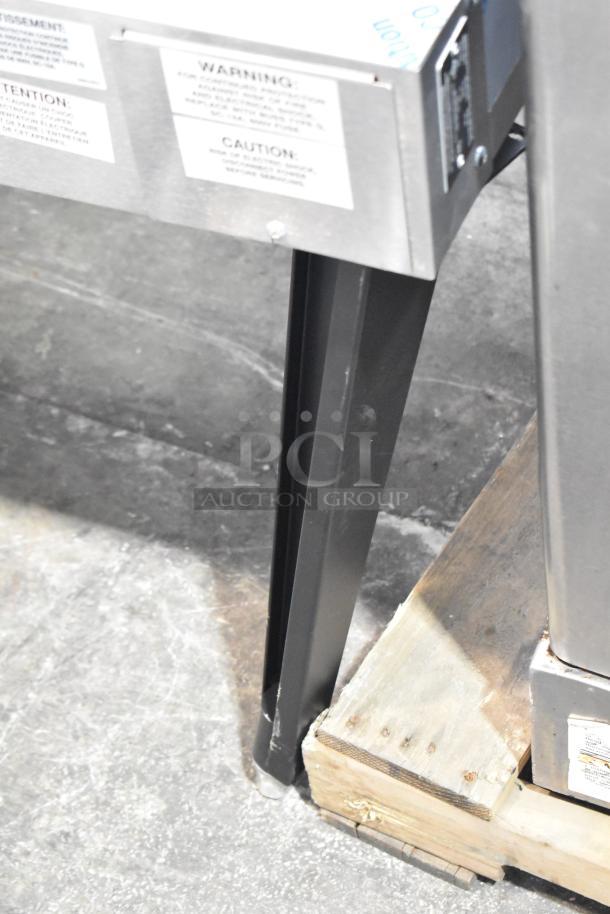 BRAND NEW Vulcan VC5ED-11D1Z convection oven leg detail, metal construction, mounted on a wooden pallet, caution labels visible.