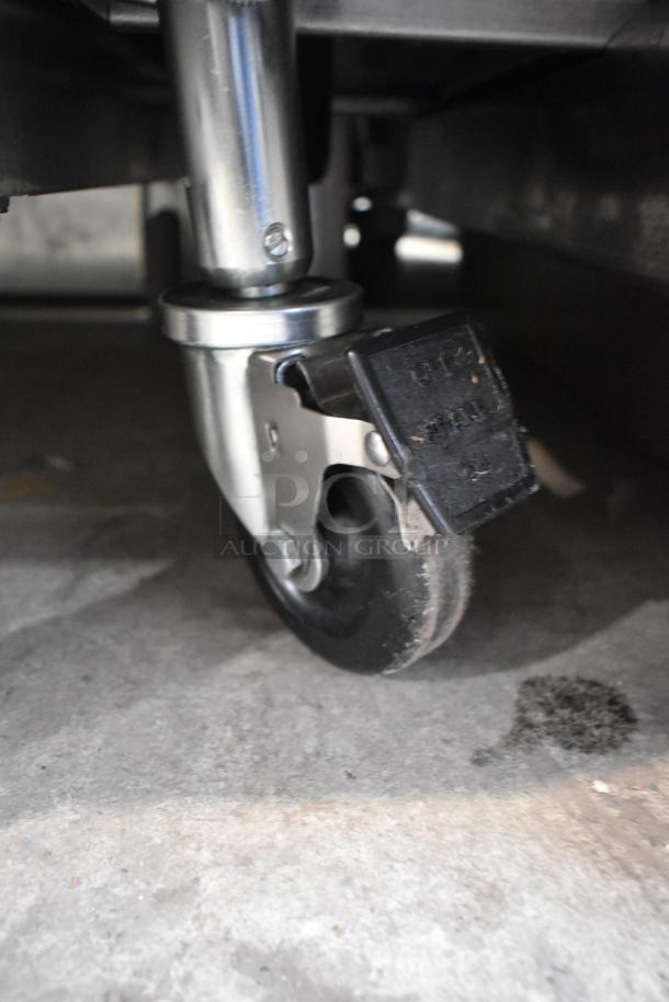 Close-up of a caster wheel from a 2024 Pitco Frialator SE18 commercial fryer, highlighting its sturdy metal construction.