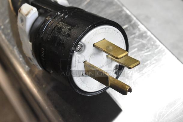 Close-up of a 208V, 3-phase power plug for a 2024 Pitco Frialator SE18 commercial fryer, featuring durable brass prongs.