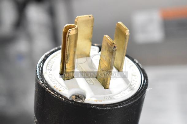 Close-up of a plug for a 2024 Pitco Frialator SE18 Commercial Electric Deep Fryer. Features brass prongs, 208 Volts, 3 Phase.