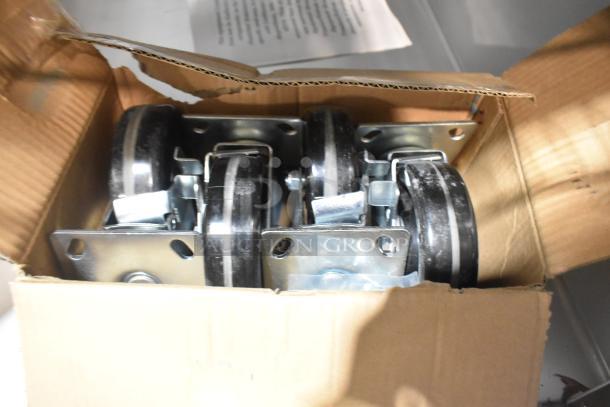 Box of commercial casters for 2022 Traulsen G10042-032 cooler. New condition, metal plates, and rubber wheels visible.