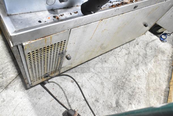 Commercial chef base with 2 drawers on casters, 115 volts, 1 phase. Stainless steel, visible wear, needs cleaning.