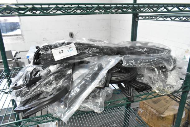 Various brand new scratch and dent items including gaskets in plastic packaging on a shelf, labeled "63 QTY VXI."