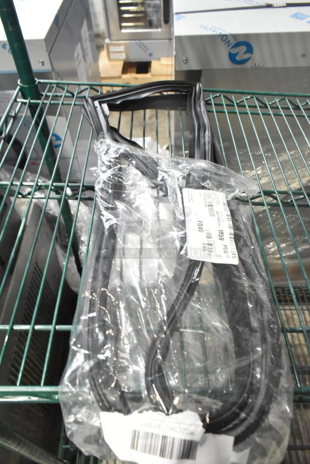 Pack of 15 new gaskets in original packaging on metal shelf, labels showing model numbers FDX6, FX16, minor scratches visible.