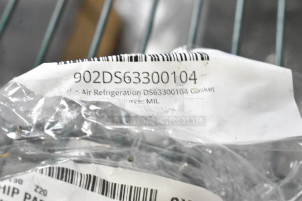 Close-up of new gasket with label "902DS63300104," indicating Air Refrigeration DS63300104. Partially visible barcode.