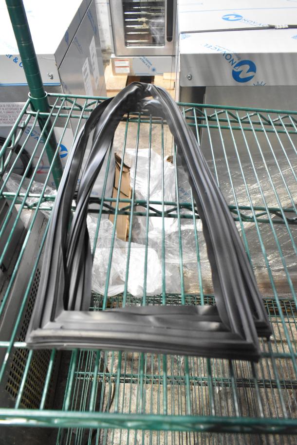 15 brand new scratch and dent gaskets, black rubber, various sizes, on metal shelves. Ideal for bidding in bulk.