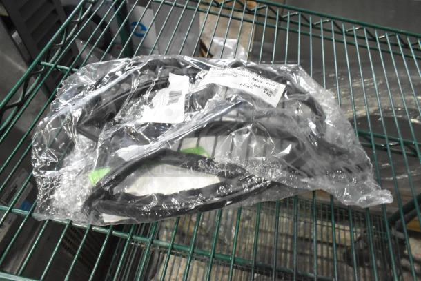 Brand new scratch and dent gaskets in sealed packaging, placed on a metal shelf. Includes label with barcode.