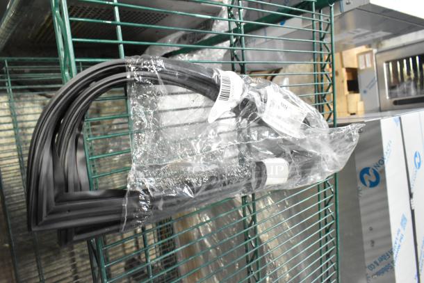 15 new gaskets, labeled, in plastic packaging on a wire shelf. Scratch and dent items included, 15 times your bid.