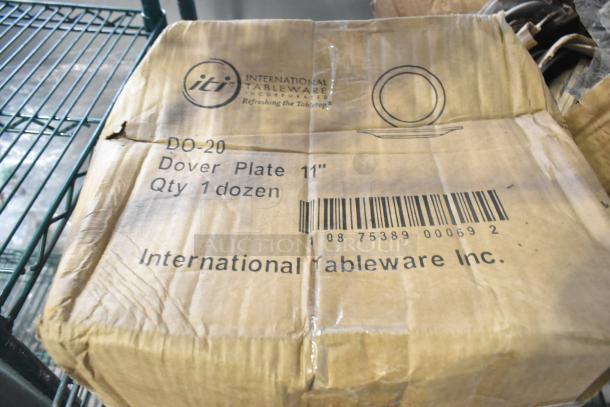 Cardboard box labeled "International Tableware Inc. Dover Plate 11", Qty 1 dozen," with a barcode and brand logo.