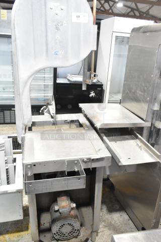 Commercial floor style meat saw, metal construction, used condition, 208-220/440 volts, includes label with model details.