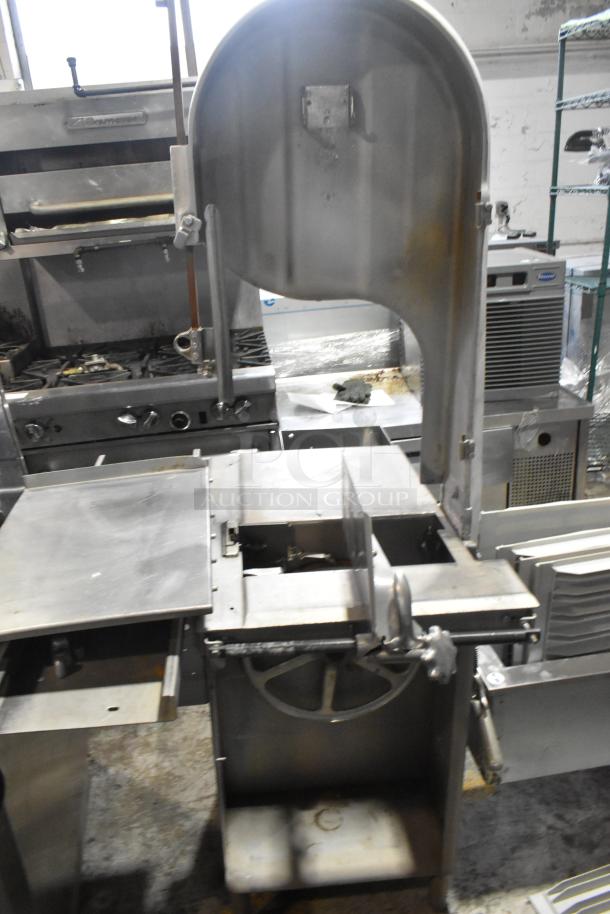 Commercial floor style meat saw, stainless steel, 208-220/440 volts, used condition, with adjustable cutting table.